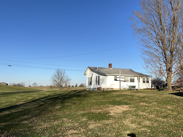 back of property featuring a yard