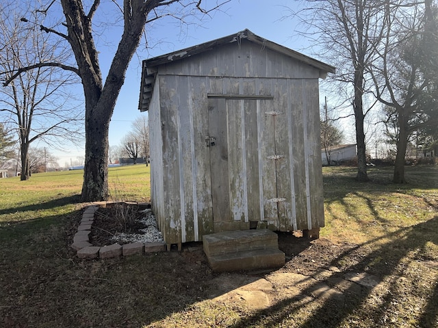 view of outbuilding featuring a lawn