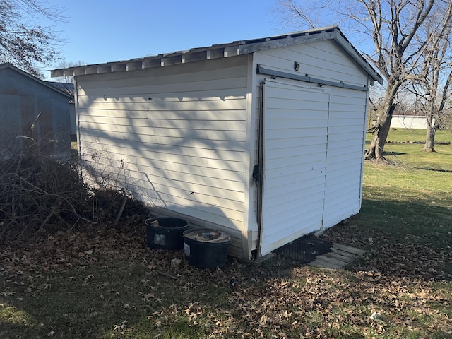 view of outbuilding featuring a yard