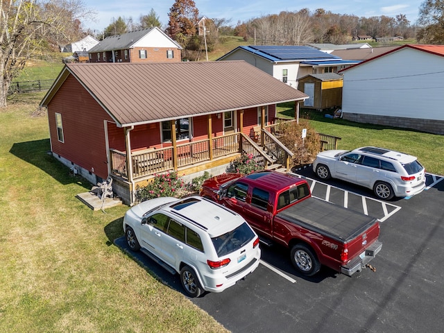 view of front of home with a front yard and a porch