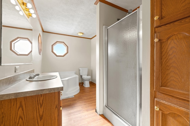 bathroom featuring hardwood / wood-style flooring, ornamental molding, a shower with shower door, and a textured ceiling