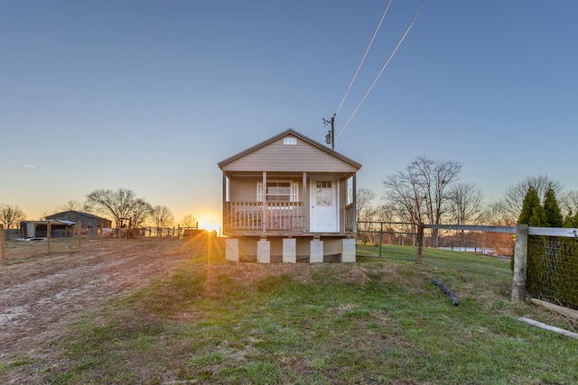 view of front of property featuring a lawn and a porch