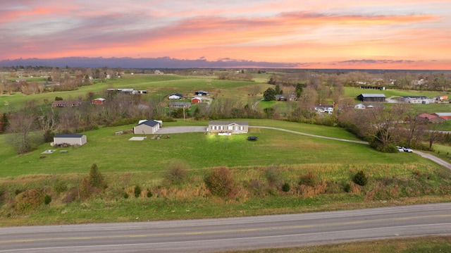 aerial view at dusk featuring a rural view