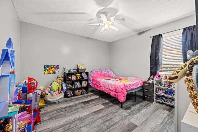 bedroom featuring ceiling fan, a textured ceiling, and hardwood / wood-style flooring