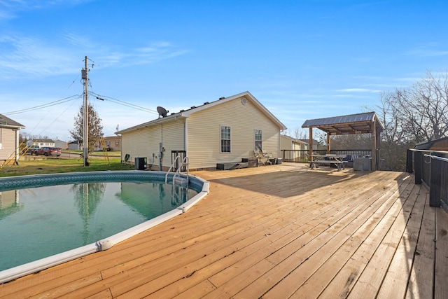 view of pool featuring central air condition unit and a wooden deck