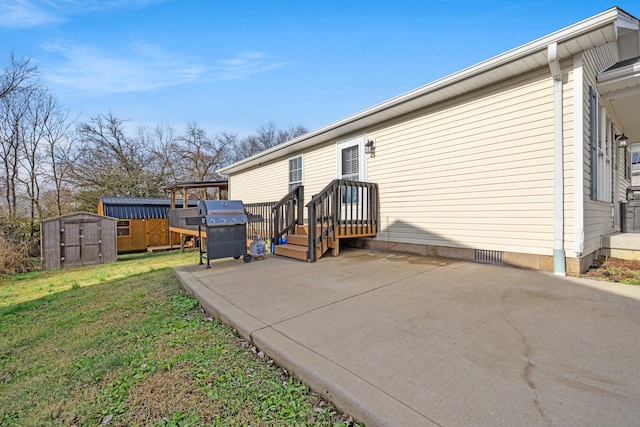 exterior space featuring a yard, a storage unit, and a patio area