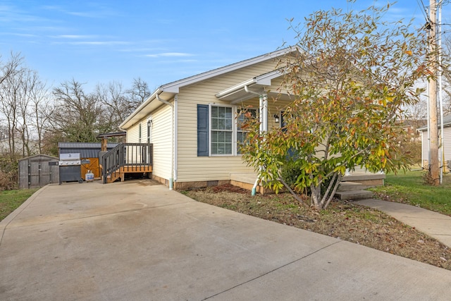 view of side of home featuring a storage unit