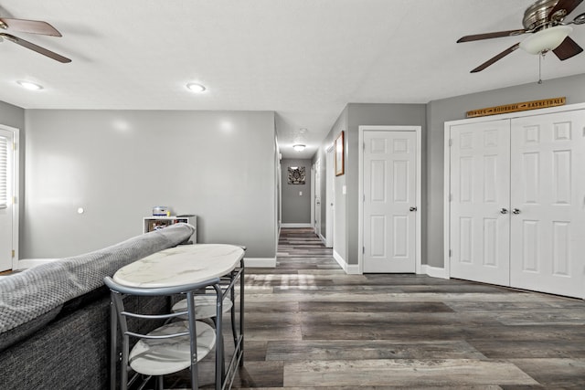 dining space featuring ceiling fan and dark hardwood / wood-style floors