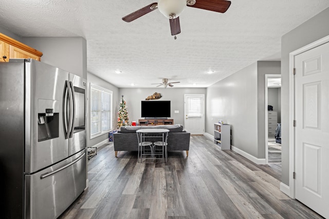 kitchen with hardwood / wood-style floors, stainless steel refrigerator with ice dispenser, a wealth of natural light, and a textured ceiling