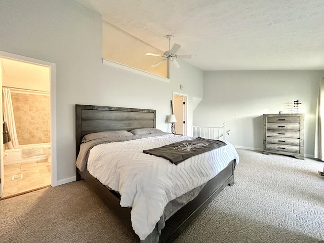 bedroom featuring high vaulted ceiling, dark colored carpet, ensuite bath, ceiling fan, and a textured ceiling