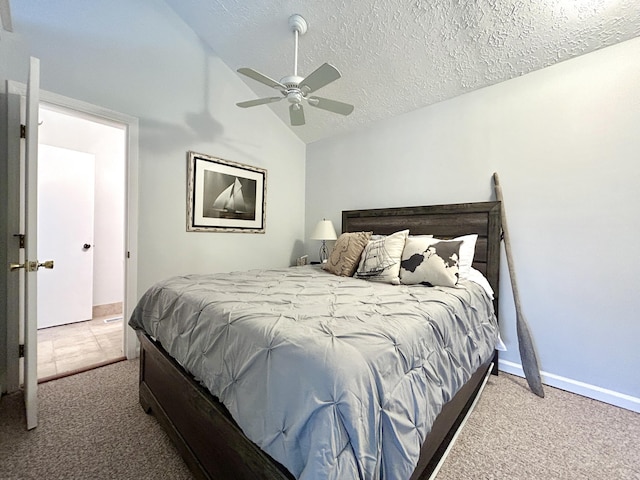 bedroom with vaulted ceiling, ceiling fan, carpet floors, and a textured ceiling