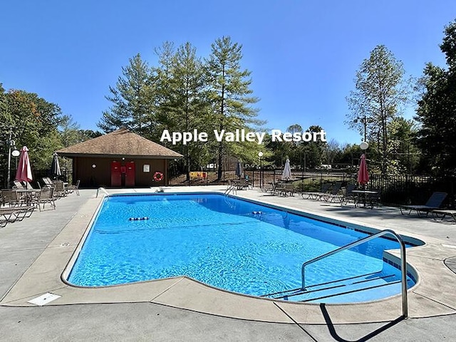 view of swimming pool with a patio