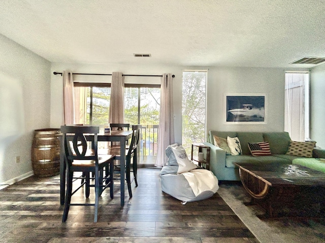 dining area featuring a textured ceiling and dark wood-type flooring