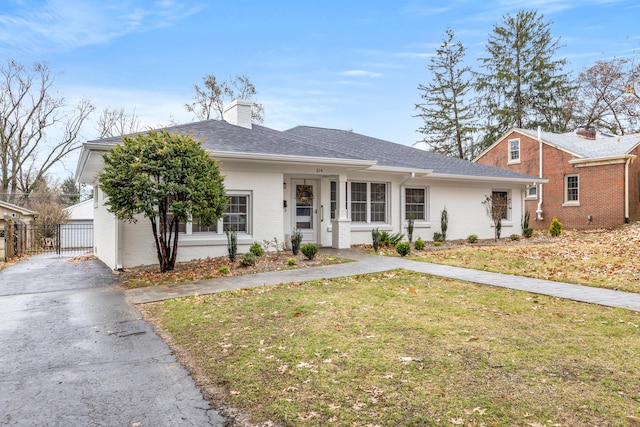 ranch-style home featuring a front yard