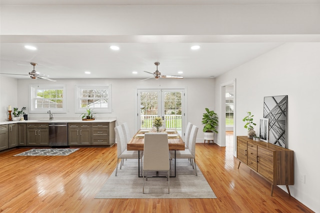 dining area with ceiling fan, light hardwood / wood-style flooring, and sink