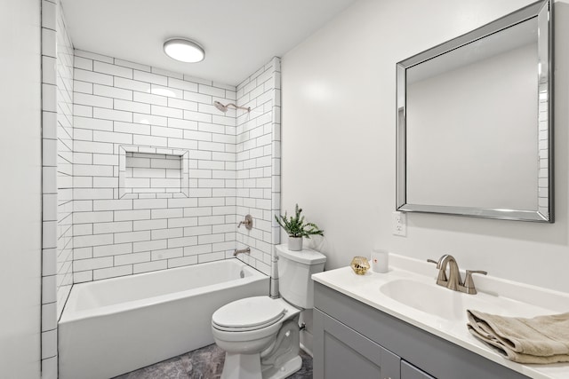 full bathroom featuring toilet, vanity, and tiled shower / bath