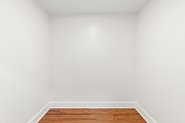 unfurnished room with hardwood / wood-style flooring