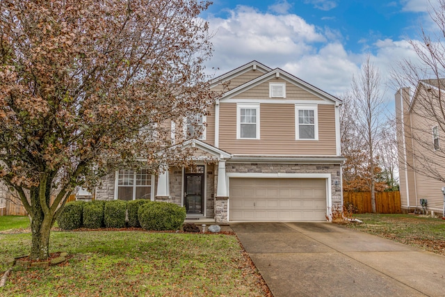 view of property featuring a garage and a front yard