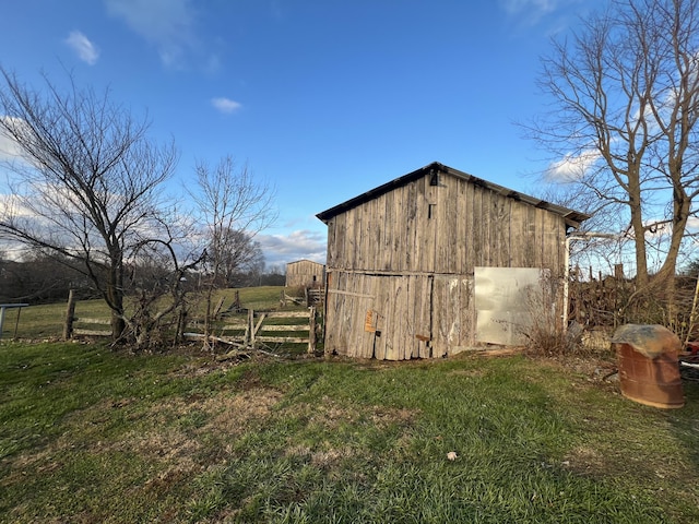 view of outdoor structure featuring a yard and a rural view