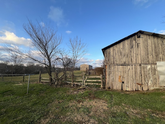 view of outbuilding with a yard and a rural view