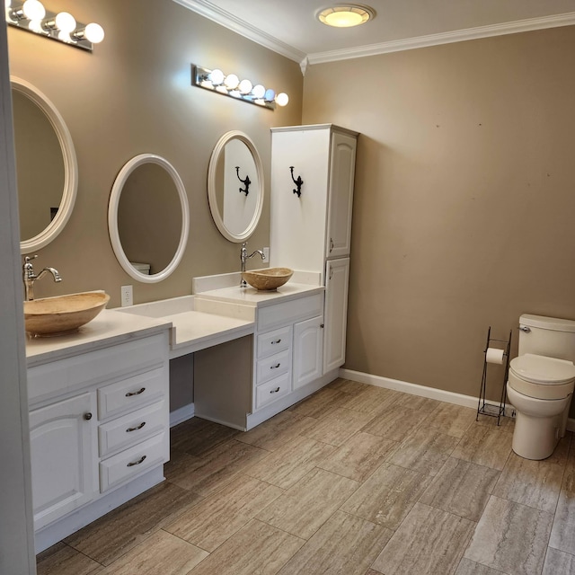 bathroom with vanity, toilet, and crown molding