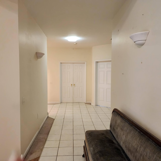 hall featuring light tile patterned floors