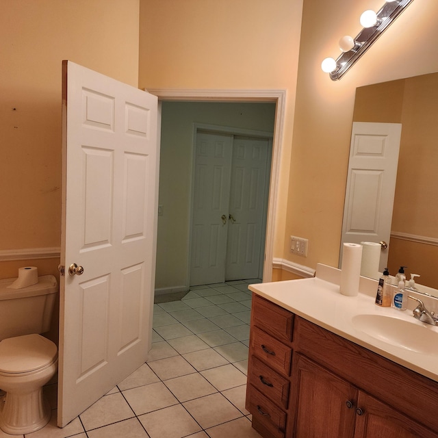 bathroom featuring tile patterned floors, vanity, and toilet