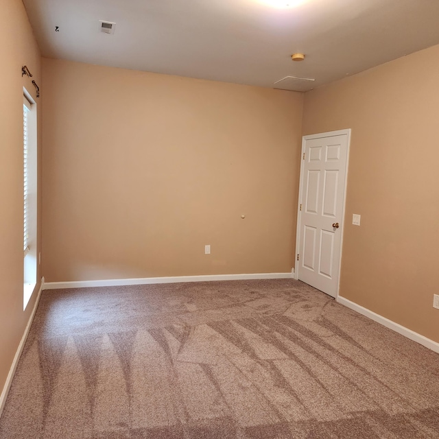 unfurnished room featuring carpet