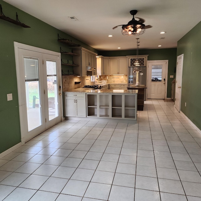 kitchen featuring ceiling fan, light stone counters, kitchen peninsula, decorative light fixtures, and light tile patterned floors