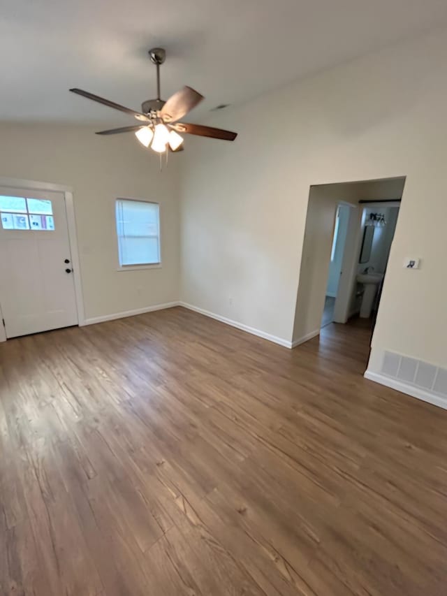 unfurnished living room with hardwood / wood-style flooring and ceiling fan