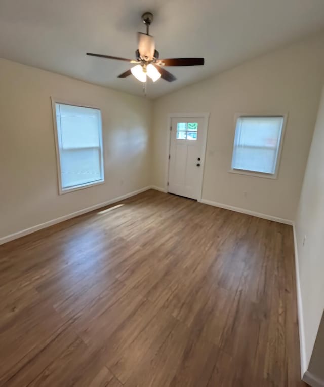 foyer featuring ceiling fan, wood-type flooring, and vaulted ceiling