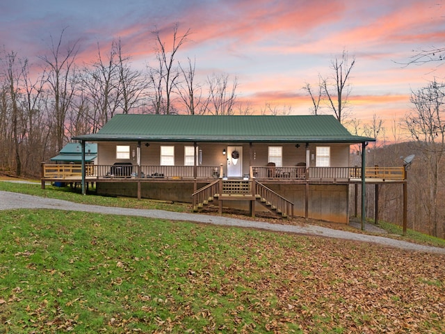 view of front facade featuring a lawn and covered porch