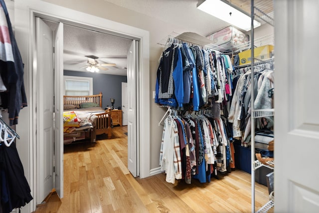 spacious closet featuring ceiling fan and hardwood / wood-style floors