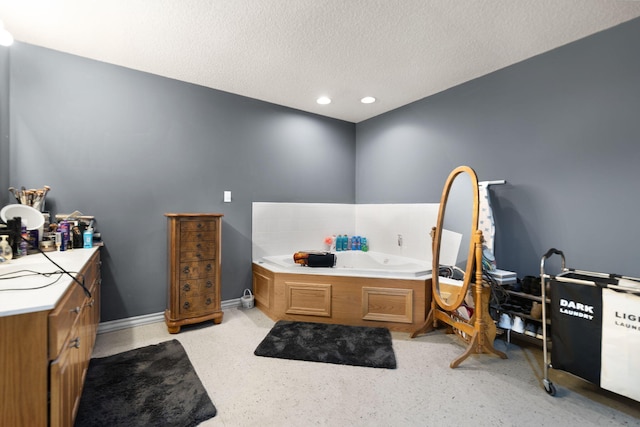 bathroom featuring a bath and a textured ceiling