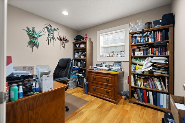 office space featuring light hardwood / wood-style flooring and a textured ceiling