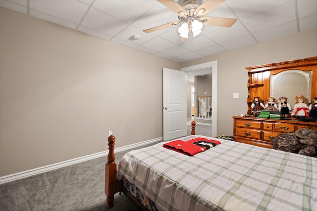 carpeted bedroom featuring a drop ceiling and ceiling fan