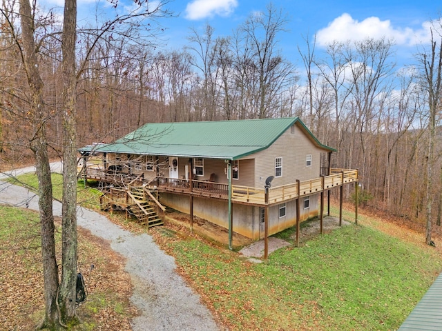 view of front of home with a front lawn, a porch, and a deck