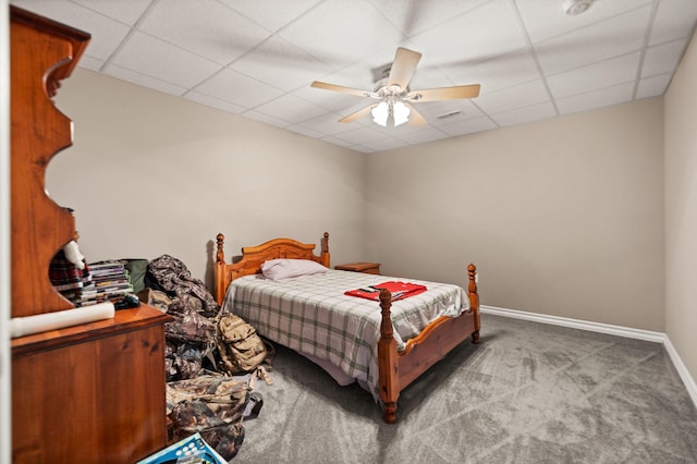 carpeted bedroom featuring a paneled ceiling and ceiling fan