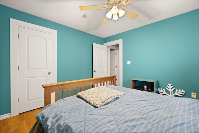 bedroom with ceiling fan and light hardwood / wood-style floors