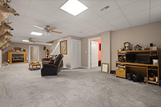 interior space featuring a paneled ceiling and ceiling fan