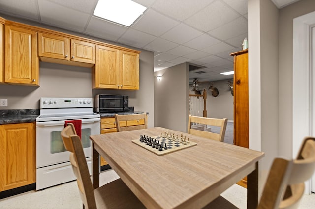 kitchen with white range with electric cooktop and a drop ceiling