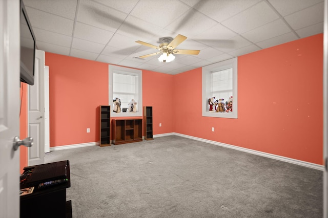 interior space featuring carpet flooring, a paneled ceiling, and ceiling fan