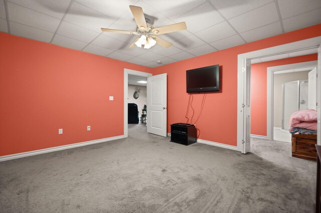 unfurnished bedroom featuring a paneled ceiling, ceiling fan, and carpet floors