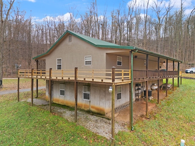 view of side of property featuring central air condition unit, a lawn, and a wooden deck