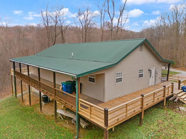 back of property with central AC and a wooden deck