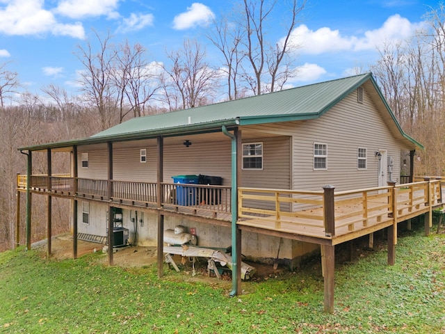 rear view of property with a wooden deck and central AC