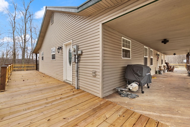 wooden terrace with a grill