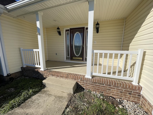 view of exterior entry with a porch