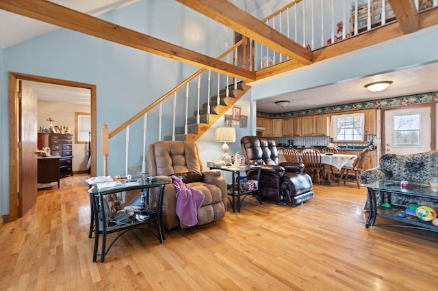 living room with light wood-type flooring and lofted ceiling