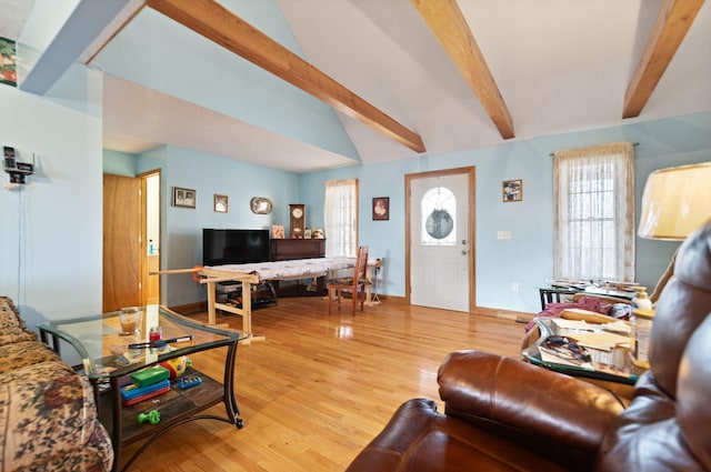 living room with lofted ceiling with beams and hardwood / wood-style flooring